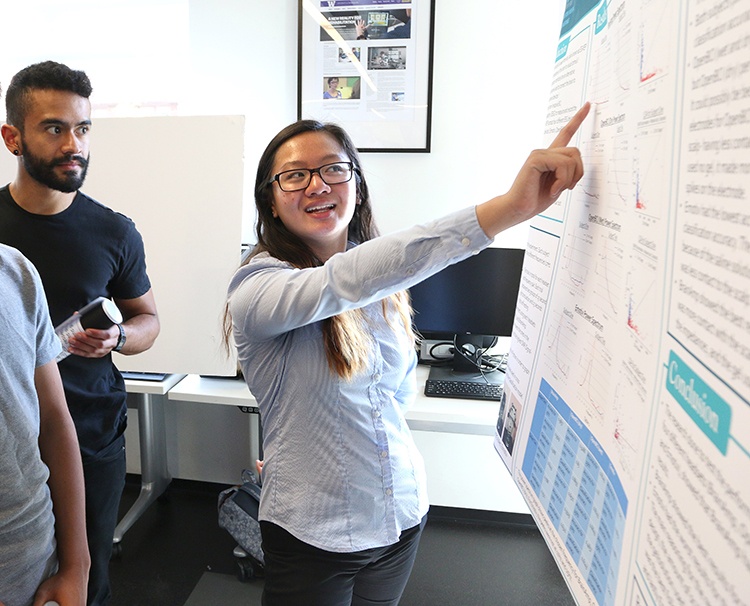 UW Math Science Upward Bound former participant, Katie Ly, explains her research project as a CSNE Young Scholars Program participant during the CSNE Summer Research Symposium